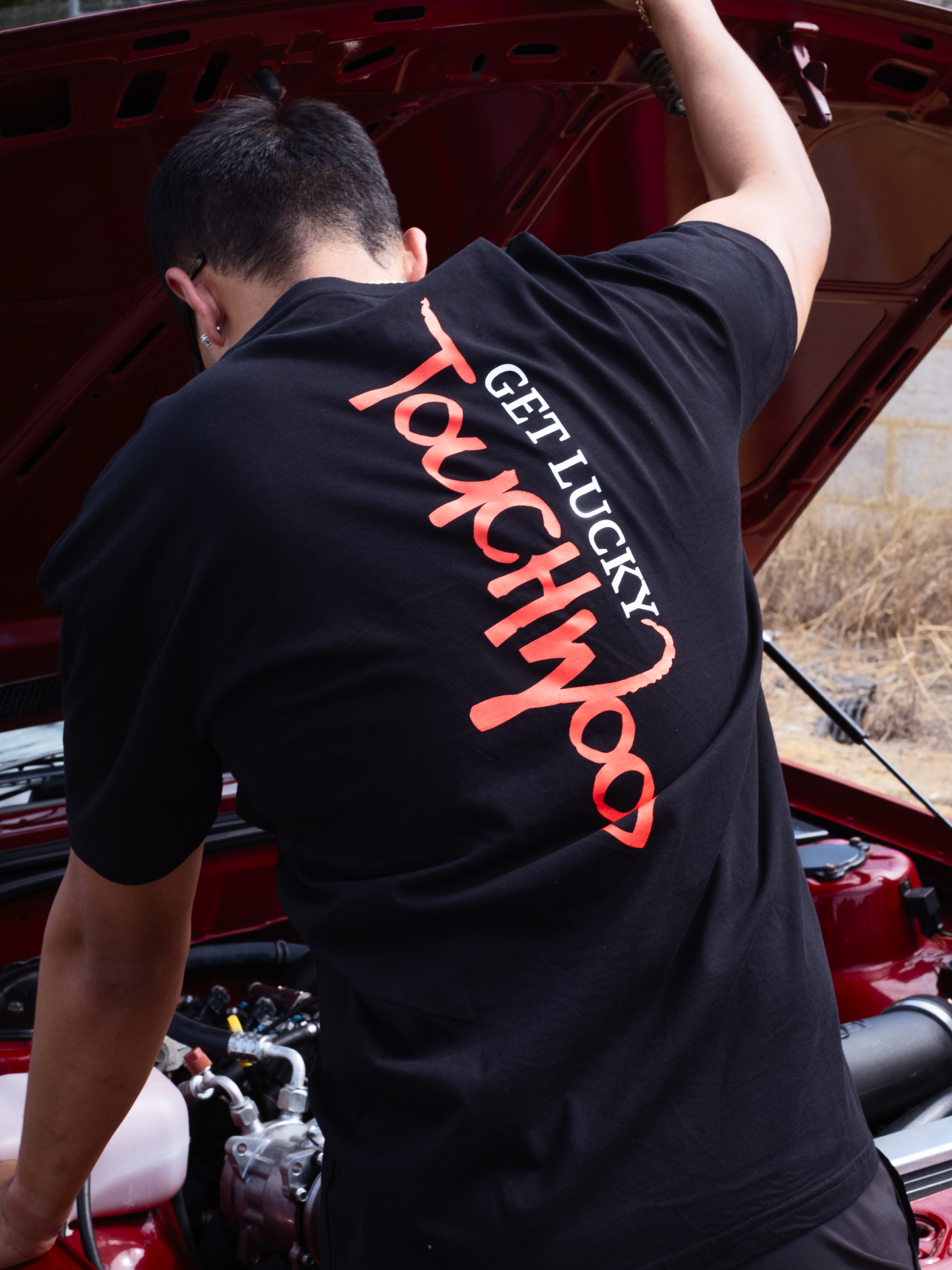 The Get Lucky Centre Logo Tee – Black & Red